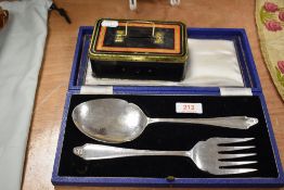 A selection of collectable coins with a serving set