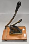 Two early 20th century desk top items including letter head stamp and paper guillotine