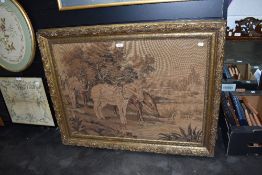 A machine woven tapestry style embroidery of horses at river side in an ornate gilt and gesso frame