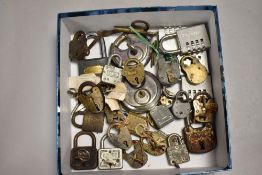 A selection of antique and later pad locks including brass examples most having keys