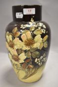 A Victorian aesthetic period ceramic vase hand decorated with flowers