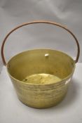 A vintage brass and cast jam pan