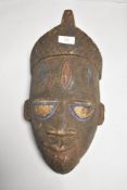 An African tribal ethnic wooden mask having polychrome decoration possibly Punu tribe