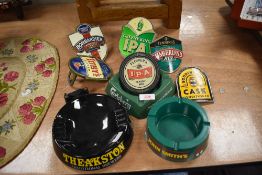 A selection of pub tavern beer tap labels and advertising ashtrays