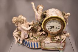 A Victorian mantel clock of large form having porcelain cherubs holding wreath on plinth base with