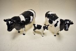 A Trio of Beswick to include Friesian Bull, Cow and calf.