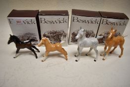 Four Beswick studies, Arab Foal 1407 x2 Palomino & Grey and Foal 997 x2 Palomino & Brown, all in