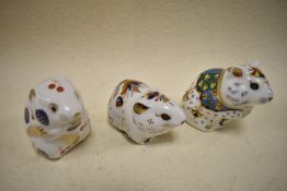 Three Royal Crown Derby studies, including Hamster and Vole, two having gold stoppers the other