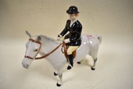 A Beswick figurine, Hunts Woman on Dapple Grey Horse, gloss finish.