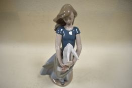 A Nao figurine, young lady holding bunny.