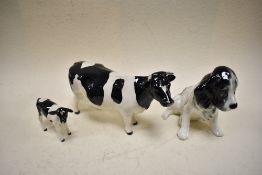 A Beswick Friesian cow, A Beswick Friesian calf and a Sylvac Spaniel.