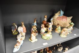 A collection of Beswick and Royal Albert Beatrix Potter studies, many having gold back stamps,