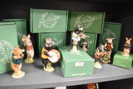 Nine Beswick pigs playing a variety of instruments having varying back stamps.
