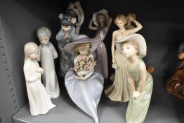 A collection of Lladro and similarly styled figurines.