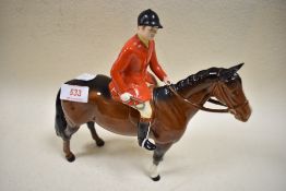 A Beswick figure of Huntsman on brown horse having minor chip to cap