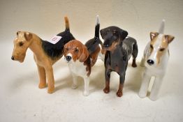 Four Beswick dog figures including Wire Haired Terrier Talavera Romulus, Beagle, Doberman