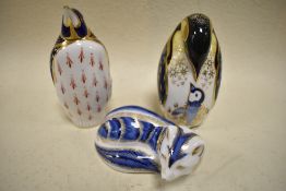 A trio of Royal Crown Derby studies, to include two penguins and an arctic fox, two with gold