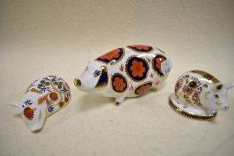 The Royal Crown Derby Pig studies in the Imari pallet, having gold stoppers.