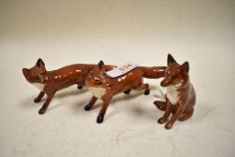 Three Beswick Fox studies, two stood and one seated.