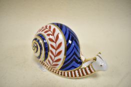 A Royal Crown Derby Snail study having silver stopper.