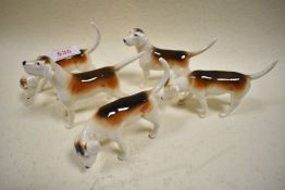 Five Beswick Fox Hounds in various poses.