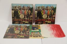 A lot of three Beatles Sgt Pepper albums all with inners - one in poor shape and the others around
