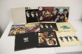 A lot of ten Beatles albums with a US Capitol White album that comes with the poster - it has been