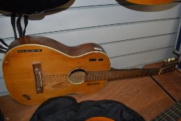 A vintage acoustic guitar, bears various labels including Klira, well loved