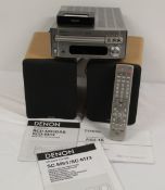 A Denon DAB Midi system with speakers . Ipod dock and remote - comes with leads and all relevant