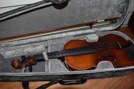 A modern unbranded violin and bow in padded case