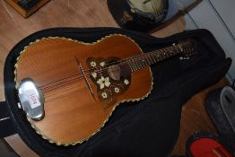 An early 20th Century guitar shaped mandolin , in later padded gig bag