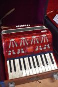 A compact piano accordion, with hard case