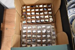 A selection of thimbles in wooden display shelfs