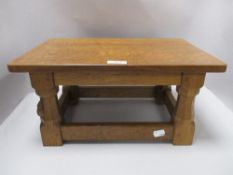 A 20th century Robert Mouseman Thompson golden oak stool from the Kilburn workshop having carved