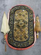 An Oriental Chinese rug of rounded rectangular form with central shaped medallion against a gull