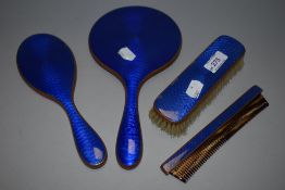An Art Deco era dressing table brush and mirror set with blue guilloche enamel backs