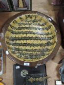 A large mid century studio pottery bowl having slip ware pattern