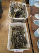 A selection of furniture and door keys with a selection of cutlery and flatwares