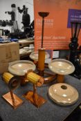 An Art Deco ceiling drop light fixture with two wall lights having copper and bakelite design
