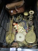 An assortment of hardware including candle sticks, horse brasses and fire side items