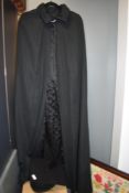 A 20th century graduation gown and mortar board cap