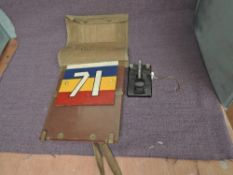 A multi coloured number plate 71, white, blue, yellow and red with typed description stating
