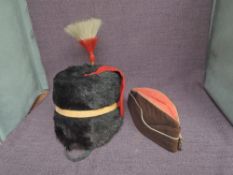 A Royal Horse Artillery Busby with white and red plume, leather chin strap, gold rope band along