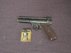 A Webley Senior .22 calibre Air Pistol with a box of pellets