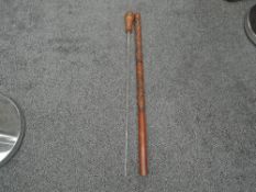 A Japanese craved Walking Stick containing a Toledo blade, overall length 86cm, the stick is older