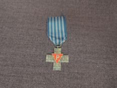 A Polish Auschwitz Cross medal 1939-1945, on reverse translated to ‘From citizens of the Polish