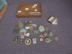 A collection of Military and other Badges including Silver ARP Badge, Border Regiment Cap Badge,