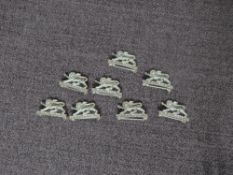 Eight small Kings Own Silver Badges, all hallmarked