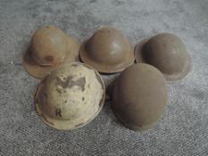 Four WW2 period Steel Helmets, one white with the letter R on the front along with a vintage Motorb
