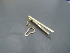 A yellow metal tie slide stamped Italy 9K having cut decoration, approx 2.5g